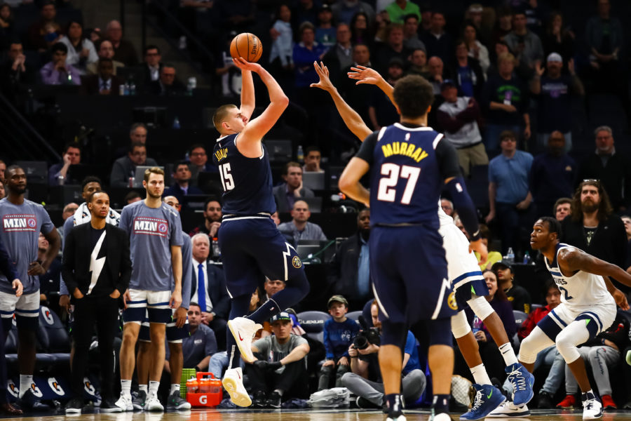 Denver Nuggets center Nikola Jokic (15) shoots the ball against the Minnesota Timberwolves during overtime at Target Center.