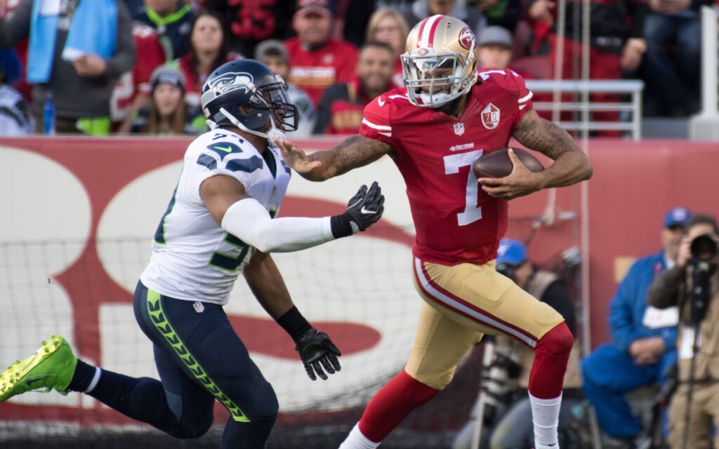 Colin Kaepernick stiff-arms Bobby Wagner in Jan. 2017. Credit: Kyle Terada, USA TODAY Sports.