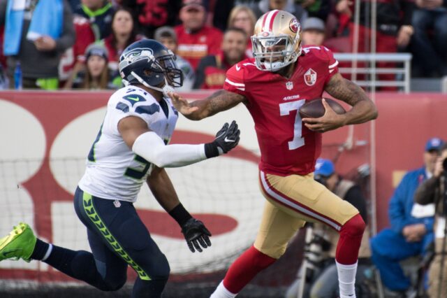 Colin Kaepernick stiff-arms Bobby Wagner in Jan. 2017. Credit: Kyle Terada, USA TODAY Sports.