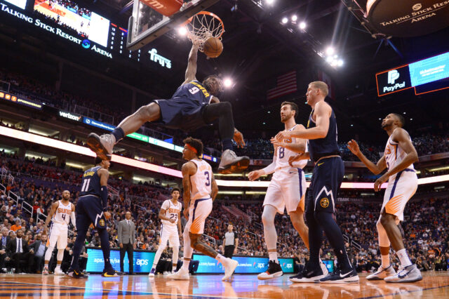 Denver Nuggets forward Jerami Grant (9) dunks over Phoenix Suns forward Kelly Oubre Jr. (3) during the second half at Talking Stick Resort Arena.