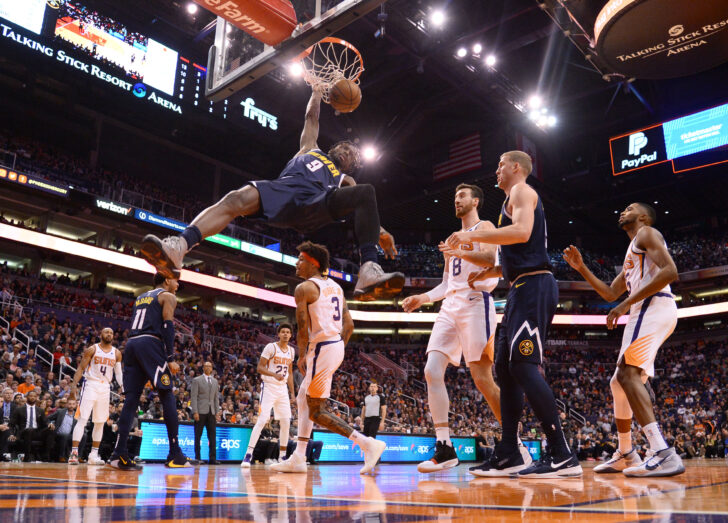 Denver Nuggets forward Jerami Grant (9) dunks over Phoenix Suns forward Kelly Oubre Jr. (3) during the second half at Talking Stick Resort Arena.