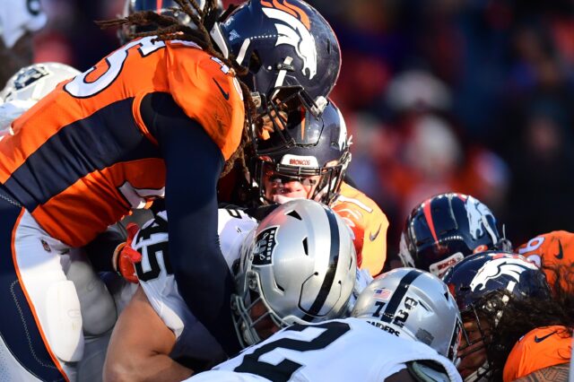 Alexander Johnson and Broncos teammates stop Ingold from scoring, the turning point of Denver's win. Credit: Ron Chenoy, USA TODAY Sports.