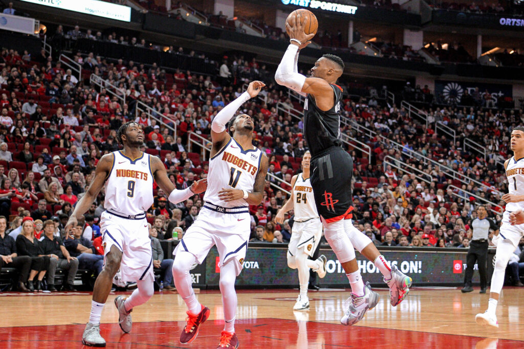 Houston Rockets guard Russell Westbrook (0) takes an inside shot against the Denver Nuggets during the second quarter at Toyota Center.