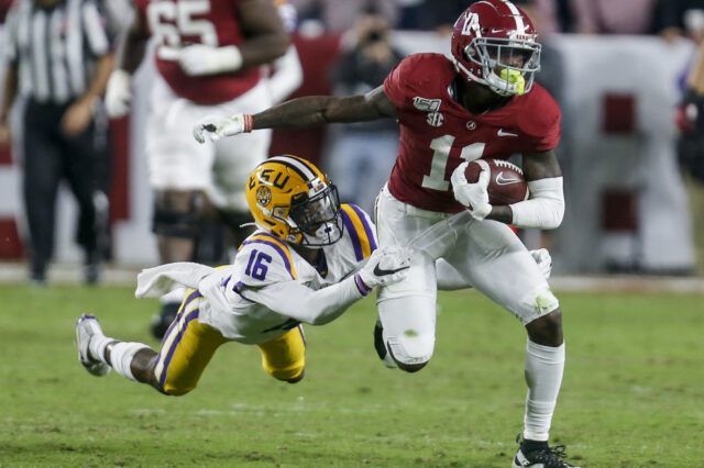 LSU Tigers cornerback Jay Ward (16) tries to bring down Alabama Crimson Tide wide receiver Henry Ruggs III (11) after a reception during the second half of an NCAA college football game at Bryant-Denny Stadium