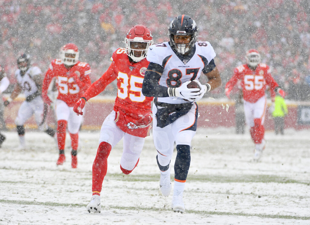 Denver Broncos tight end Noah Fant (87) runs the ball as Kansas City Chiefs cornerback Charvarius Ward (35) defends during the first half at Arrowhead Stadium.