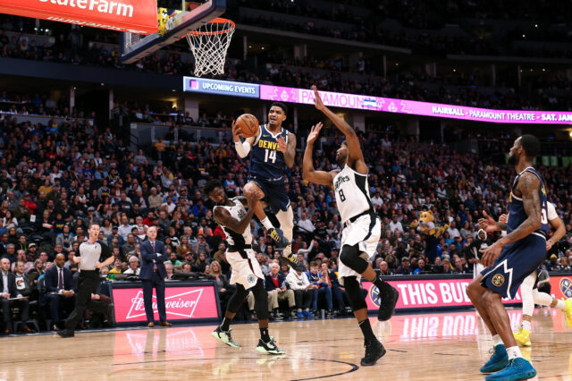 Denver Nuggets guard Gary Harris (14) drives to the net against Los Angeles Clippers guard Patrick Beverley (21) and forward Maurice Harkless (8) in the second quarter at the Pepsi Center.