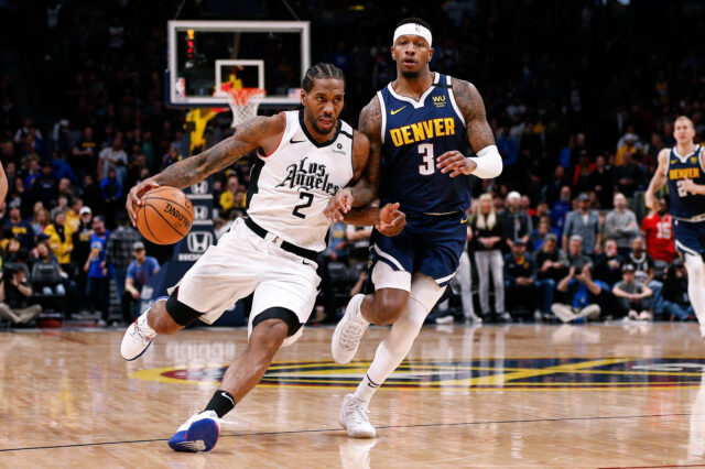 Los Angeles Clippers forward Kawhi Leonard (2) drives to the net against Denver Nuggets forward Torrey Craig (3) in the fourth quarter at the Pepsi Center.