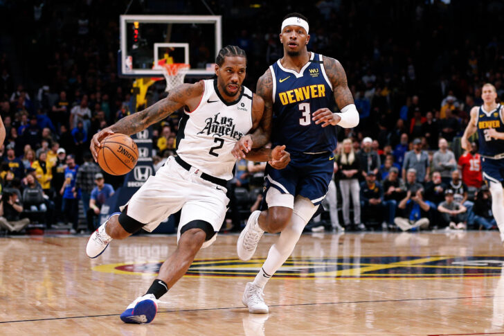 Los Angeles Clippers forward Kawhi Leonard (2) drives to the net against Denver Nuggets forward Torrey Craig (3) in the fourth quarter at the Pepsi Center.