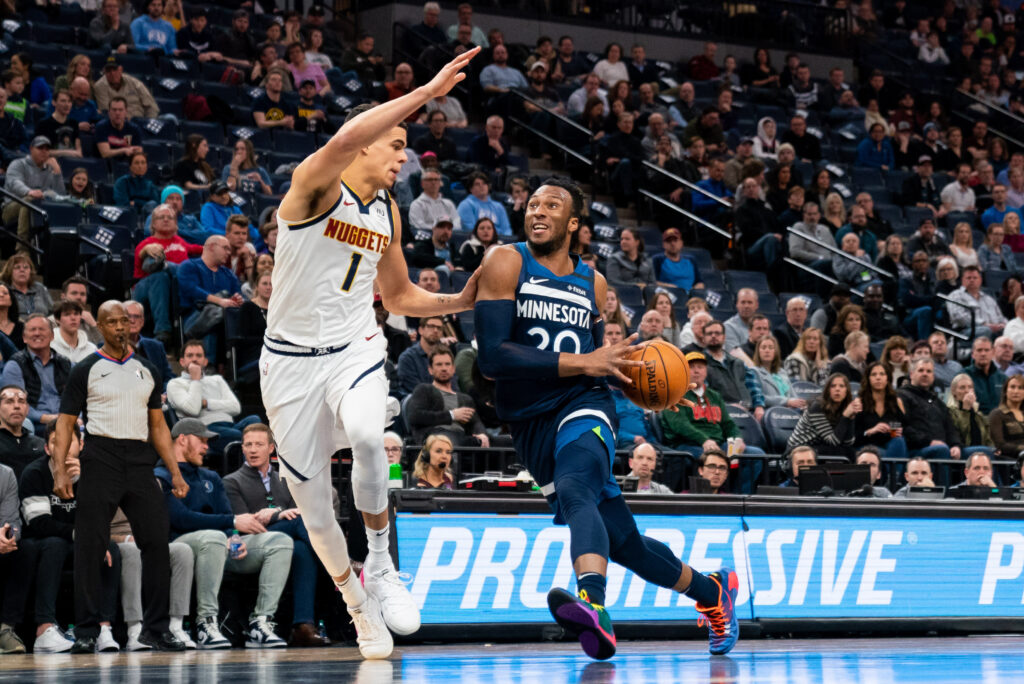 Minnesota Timberwolves guard Josh Okogie (20) dribbles in the third quarter against Denver Nuggets forward Michael Porter Jr. (1) at Target Center.