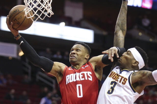 Houston Rockets guard Russell Westbrook (0) shoots against Denver Nuggets forward Torrey Craig (3) in the first quarter at Toyota Center.