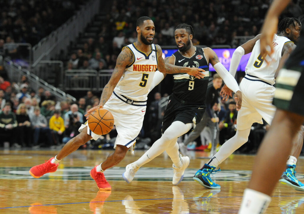 Denver Nuggets forward Will Barton (5) dribbles past Milwaukee Bucks Milwaukee Bucks guard Wesley Matthews (9) during the third quarter at Fiserv Forum.