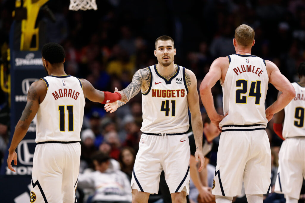 Denver Nuggets forward Juancho Hernangomez (41) reacts with guard Monte Morris (11) and forward Mason Plumlee (24) after a play in the fourth quarter against the Washington Wizards at the Pepsi Center.