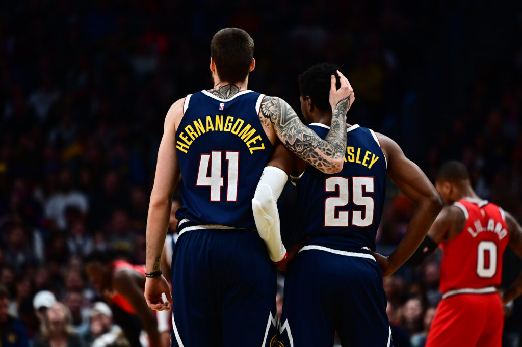 Denver Nuggets forward Juan Hernangomez (41) and guard Malik Beasley (25) embrace during the second half against the Portland Trail Blazers at Pepsi Center.