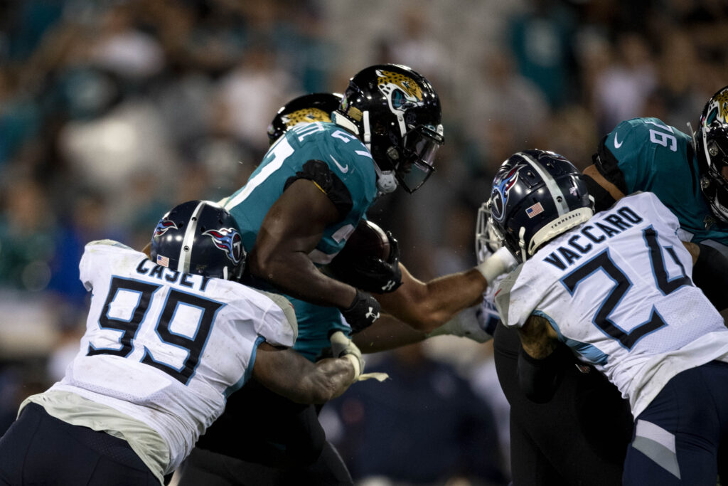 Jacksonville Jaguars running back Leonard Fournette (27) runs the ball as Tennessee Titans defensive end Jurrell Casey (99) defends during the fourth quarter at TIAA Bank Field.