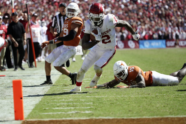 Oklahoma Sooners wide receiver CeeDee Lamb (2) runs over Texas Longhorns defensive back Chris Brown (15) and scores a touchdown during the second half at the Cotton Bowl.