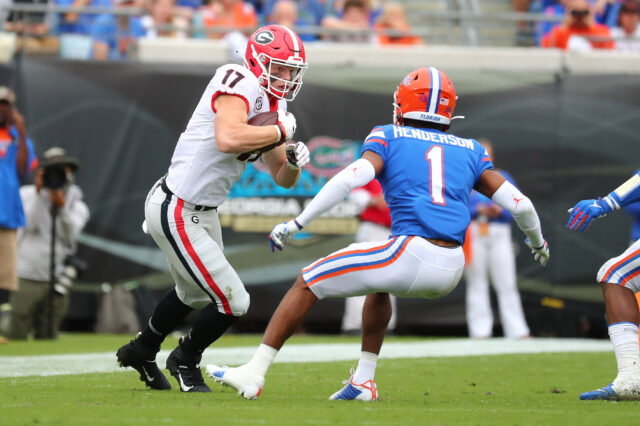 Georgia Bulldogs tight end Eli Wolf (17) runs the ball against Florida Gators defensive back CJ Henderson (1) during the first half at TIAA Bank Field.