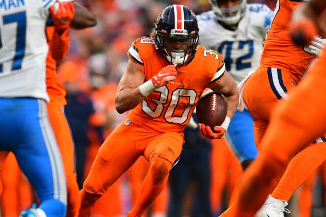 Phillip Lindsay runs between the tackles. Credit: Ron Chenoy, USA TODAY Sports.