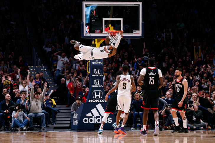 Denver Nuggets forward Torrey Craig (3) hangs off the rim after dunking the ball as forward Will Barton III (5) and Houston Rockets center Clint Capela (15) and guard Austin Rivers (25) look on in the fourth quarter at the Pepsi Center.