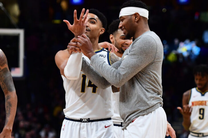 Denver Nuggets forward Torrey Craig (3) grabs the arm of guard Gary Harris (14) following a basket in the fourth quarter against the Toronto Raptors at the Pepsi Center.