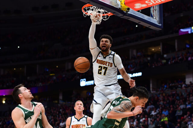 Denver, Colorado, USA; Denver Nuggets guard Jamal Murray (27) finishes off a basket over Milwaukee Bucks forward D.J. Wilson (5) in the third quarter at the Pepsi Center.