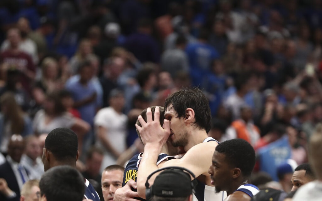 Dallas Mavericks center Boban Marjanovic (51) hugs Denver Nuggets center Nikola Jokic (15) after the game at American Airlines Center.