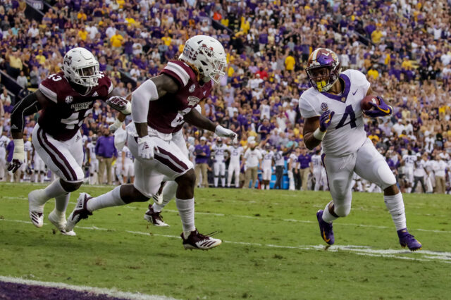 LSU Tigers running back Nick Brossette (4) is pursued by Mississippi State Bulldogs linebacker Willie Gay Jr. (6) during the first quarter at Tiger Stadium