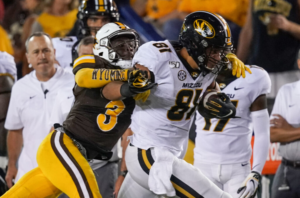 Missouri Tigers tight end Albert Okwuegbunam (81) is tackled by Wyoming Cowboys safety Alijah Halliburton (3) during the third quarter at Jonah Field War Memorial Stadium.