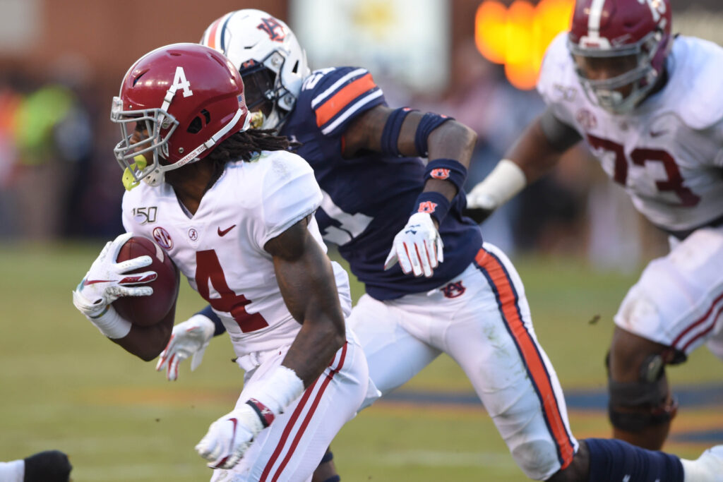 Alabama Crimson Tide wide receiver Jerry Jeudy (4) runs the ball ahead of Auburn Tigers defensive back Smoke Monday (21) during the second quarter at Jordan-Hare Stadium.