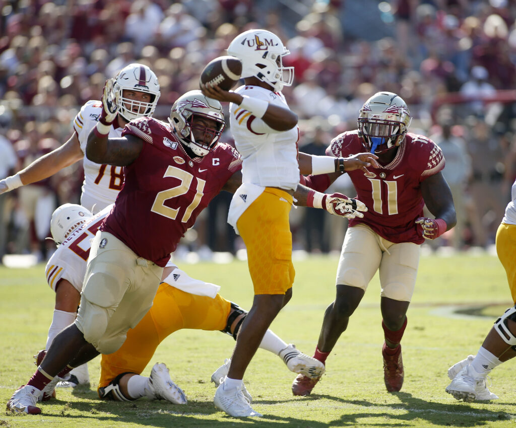 Florida State Seminoles defensive tackle Marvin Wilson (21) and Florida State Seminoles defensive end Janarius Robinson (11) pressure Louisiana Monroe Warhawks quarterback Caleb Evans (6)at Doak Campbell Stadium. Florida State is hosting the Louisiana Monroe Warhawks.