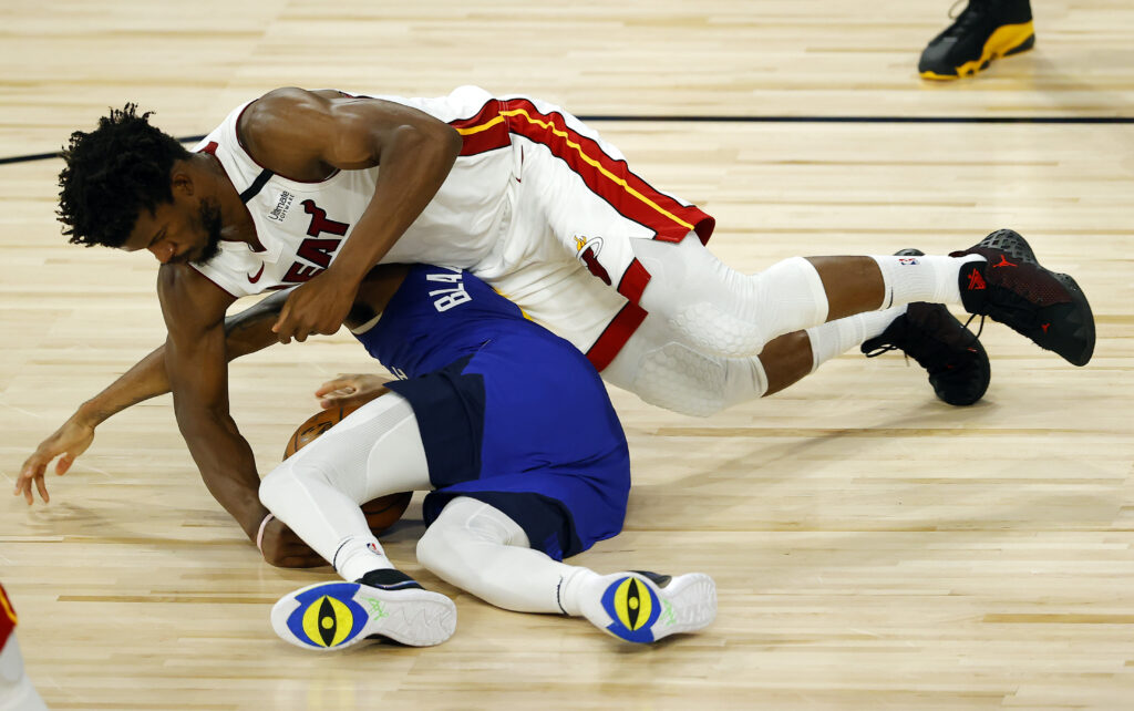 Monte Morris #11 of the Denver Nuggets looses the ball against Jimmy Butler #22 of the Miami Heat at HP Field House at ESPN Wide World Of Sports Complex on August 01, 2020 in Lake Buena Vista, Florida.