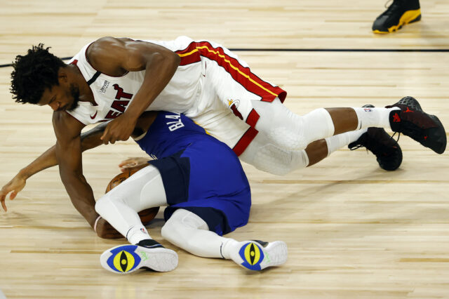 Monte Morris #11 of the Denver Nuggets looses the ball against Jimmy Butler #22 of the Miami Heat at HP Field House at ESPN Wide World Of Sports Complex on August 01, 2020 in Lake Buena Vista, Florida.