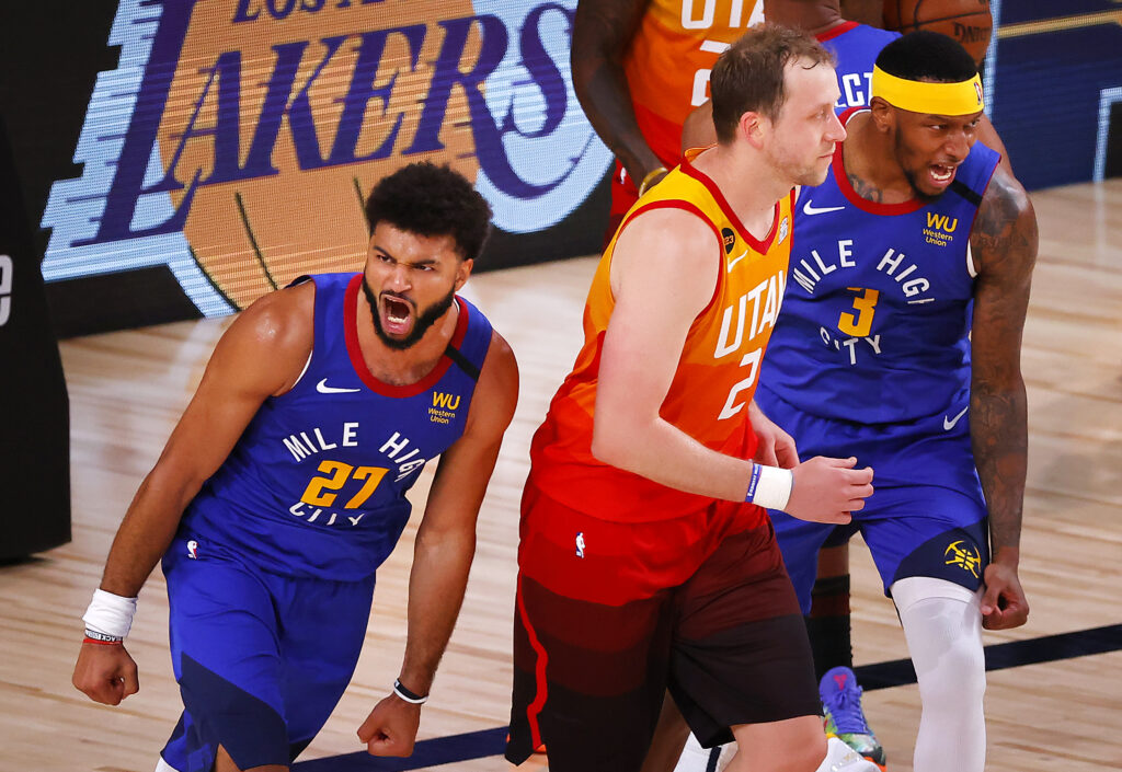 Jamal Murray #27 of the Denver Nuggets reacts after a basket with Torrey Craig #3 of the Denver Nuggets and as Joe Ingles #2 of the Utah Jazz looks on during the fourth quarter at The Arena at ESPN Wide World Of Sports Complex.