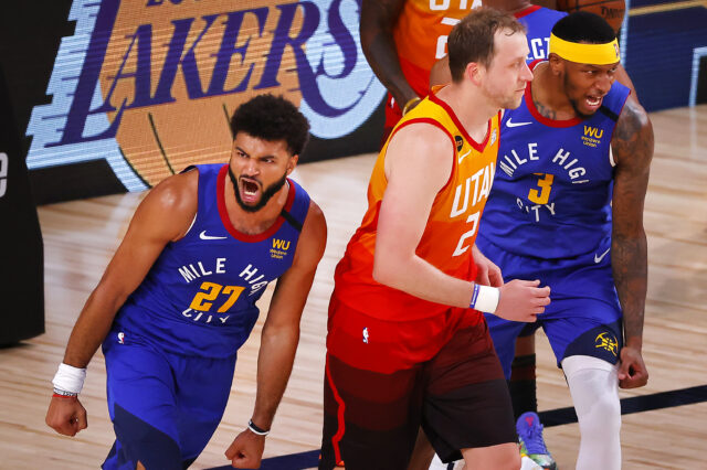 Jamal Murray #27 of the Denver Nuggets reacts after a basket with Torrey Craig #3 of the Denver Nuggets and as Joe Ingles #2 of the Utah Jazz looks on during the fourth quarter at The Arena at ESPN Wide World Of Sports Complex.