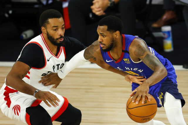 Monte Morris #11 of the Denver Nuggets drives the ball against Norman Powell #24 of the Toronto Raptors during the third quarter at The Field House at ESPN Wide World Of Sports Complex on August 14, 2020 in Lake Buena Vista, Florida.