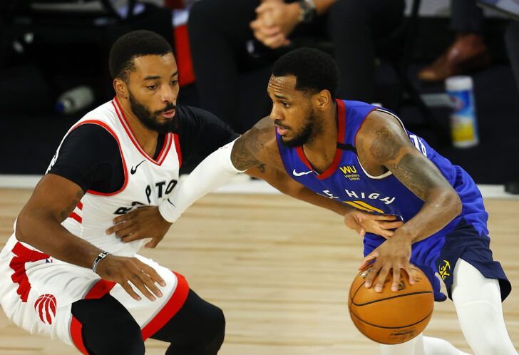 Monte Morris #11 of the Denver Nuggets drives the ball against Norman Powell #24 of the Toronto Raptors during the third quarter at The Field House at ESPN Wide World Of Sports Complex on August 14, 2020 in Lake Buena Vista, Florida.