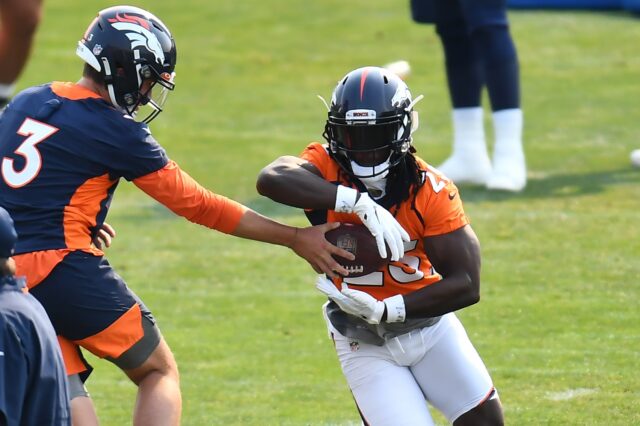 Drew Lock hands off to Melvin Gordon. Credit: Ron Chenoy, USA TODAY Sports.