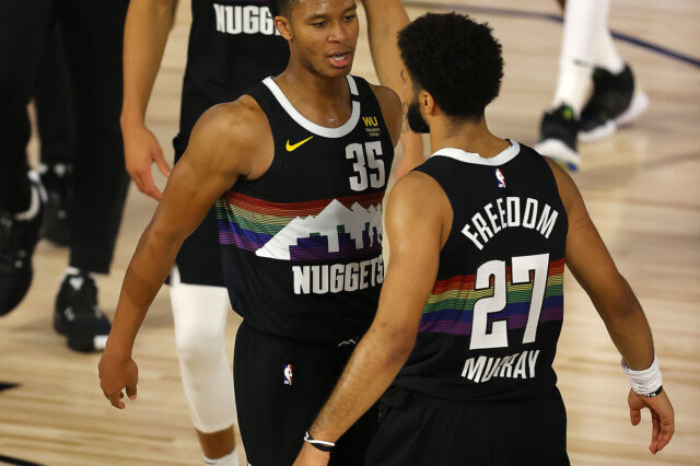 Jamal Murray #27 of the Denver Nuggets and PJ Dozier #35 of the Denver Nuggets react after their win over Utah Jazz in game five of the first round of the 2020 NBA Playoffs at ESPN Wide World of Sports Complex.