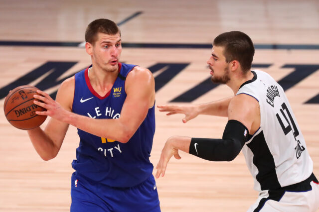 Denver Nuggets center Nikola Jokic (15) is defended by LA Clippers center Ivica Zubac (40) in the third quarter of a NBA basketball game at AdventHealth Arena.