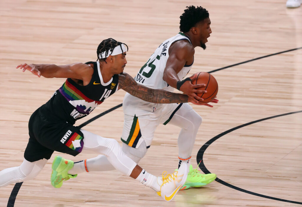 Denver Nuggets guard Gary Harris (14) pressures Utah Jazz guard Donovan Mitchell (45) during the second half of game seven of the first round of the 2020 NBA Playoffs at ESPN Wide World of Sports Complex.