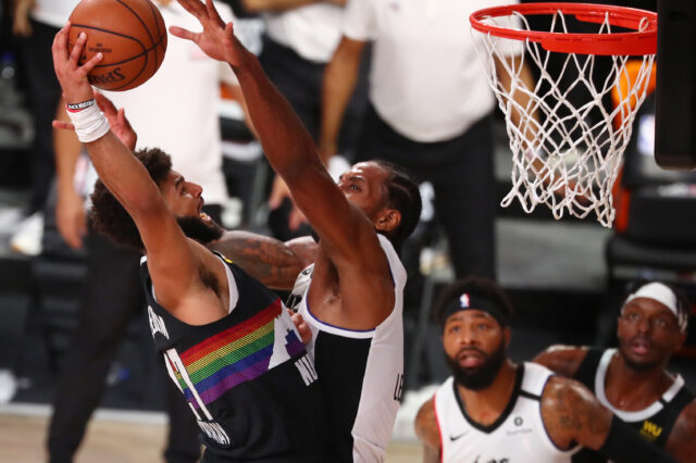 Denver Nuggets guard Jamal Murray (27) shoots against LA Clippers forward Kawhi Leonard (right) during the second half of game three of the second round of the 2020 NBA Playoffs at AdventHealth Arena.