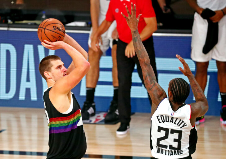 Denver Nuggets center Nikola Jokic (15) shoots the ball against LA Clippers guard Lou Williams (23) during the fourth quarter in game six of the second round of the 2020 NBA Playoffs at ESPN Wide World of Sports Complex.