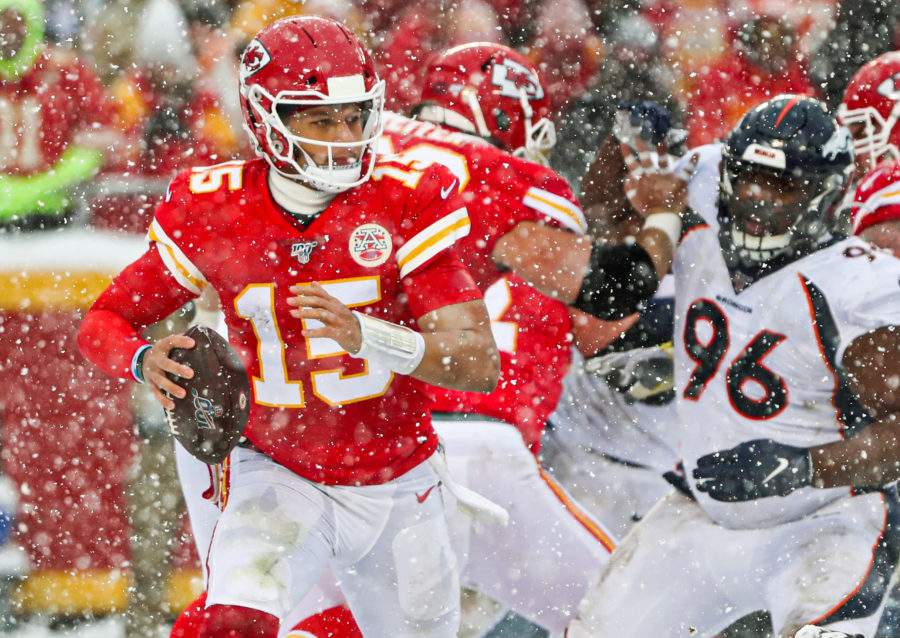 Kansas City Chiefs quarterback Patrick Mahomes (15) scrambles from Denver Broncos defensive tackle Shelby Harris (96) during the second half at Arrowhead Stadium.