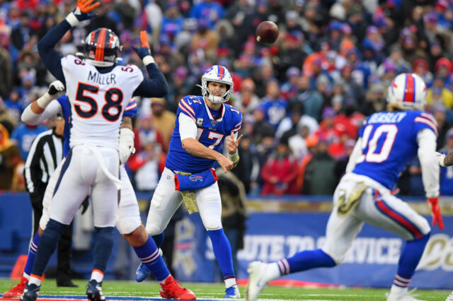 Buffalo Bills quarterback Josh Allen (17) passes the ball in the direction of wide receiver Cole Beasley (10) as Denver Broncos outside linebacker Von Miller (58) pressures during the fourth quarter at New Era Field.