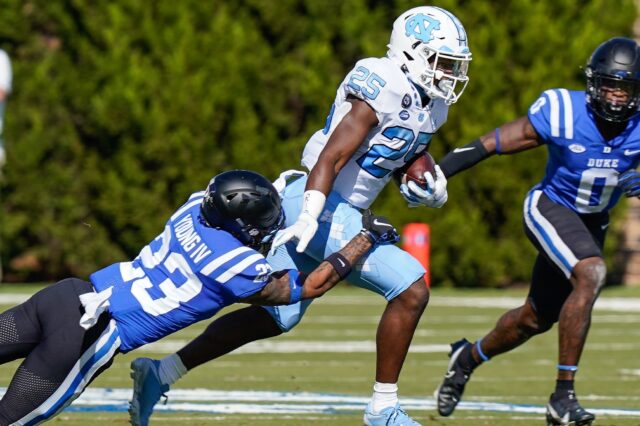 Javonte Williams runs through tackles, like he's known to do. Credit: Jim Dedmon, USA TODAY Sports.