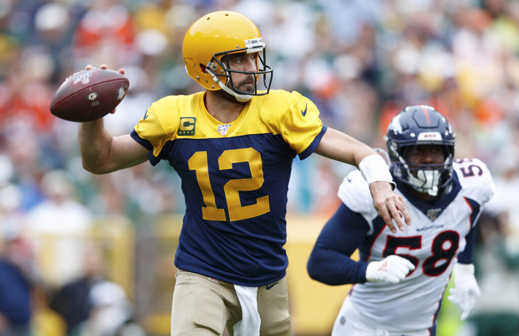 Green Bay Packers quarterback Aaron Rodgers (12) throws a pass under pressure from Denver Broncos linebacker Von Miller (58) during the second quarter at Lambeau Field.