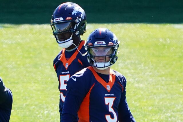 Teddy Bridgewater looks over Drew Lock's shoulder on Day 1 of OTAs in Denver. Credit: Ron Chenoy, USA TODAY Sports.