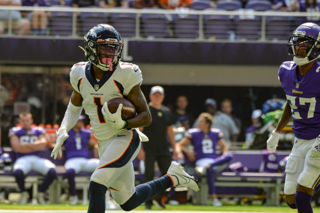 Denver Broncos wide receiver K.J. Hamler (1) catches an 80 yard touchdown pass from quarterback Drew Lock (not pictured) as Minnesota Vikings cornerback Cameron Dantzler (27) defends at U.S. Bank Stadium.