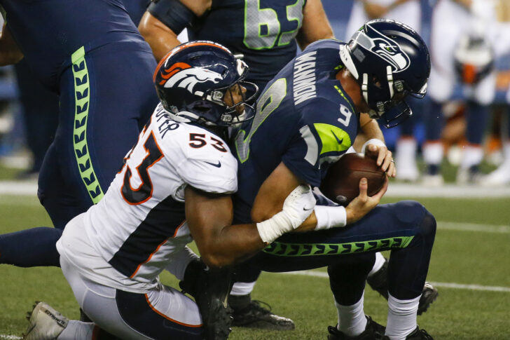 Denver Broncos linebacker Jonathon Cooper (53) sacks Seattle Seahawks quarterback Sean Mannion (9) during the fourth quarter at Lumen Field.