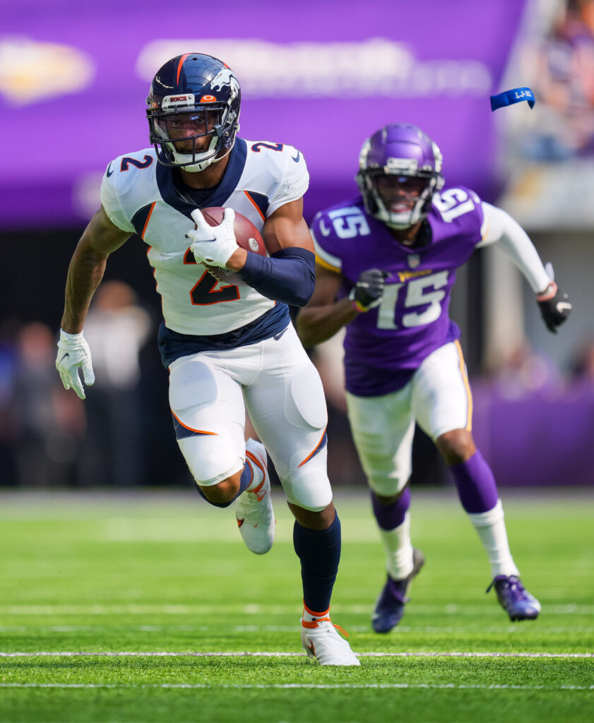 Denver Broncos cornerback Pat Surtain II (2) intercepts the ball for a touchdown against the Minnesota Vikings in the second quarter at U.S. Bank Stadium.