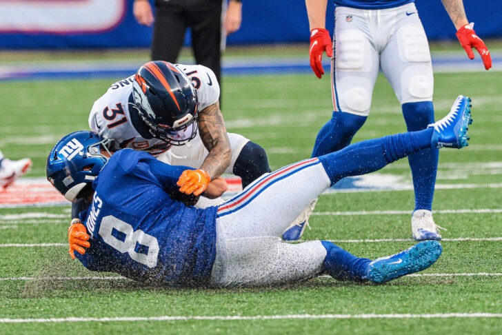 Denver Broncos free safety Justin Simmons (31) tackles New York Giants quarterback Daniel Jones (8) during the second half at MetLife Stadium.